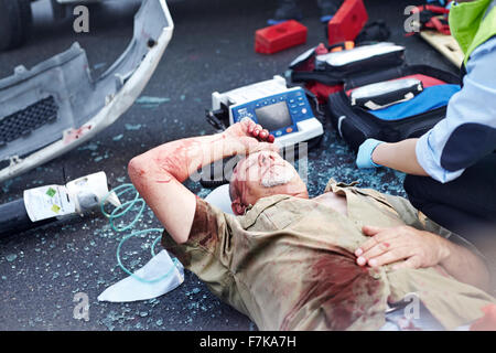 Car accident victim laying in road Stock Photo