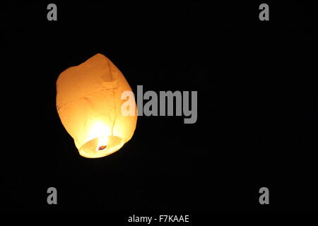 Flying Chinese lantern in the night sky Stock Photo