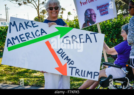 Protesters holding signs denouncing Donald Trump at a political rally for Trump in Sarasota, FL Stock Photo