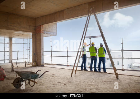 Construction workers at highrise construction site Stock Photo