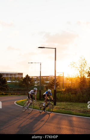 People cycling on track outside the Velodrome, Queen Elizabeth Olympic Park, Stratford, London, UK Stock Photo