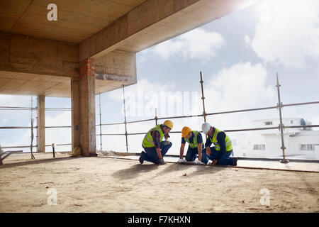 Construction workers working at highrise construction site Stock Photo