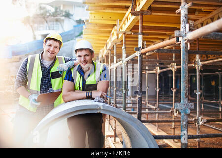 Portrait confident engineers with clipboard at construction site Stock Photo