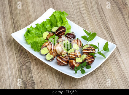 Escargot with parsley butter with salat leaves and mint Stock Photo