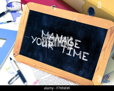 Manage Your Time. Motivational Quote on Small Chalkboard. Stock Photo