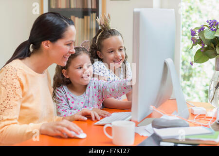 Mother and daughters using computer Stock Photo