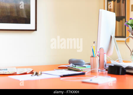 Computer and paperwork on desk in home office Stock Photo