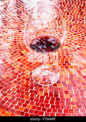 A glass of wine on a tile table during a wine tasting at the Carlton Winemakers Studio in Carlton, Oregon. Stock Photo