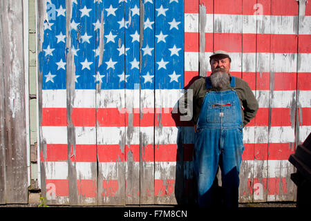 Howard the teacher poses in front of US flag on his shed, near Augusta, Maine Stock Photo