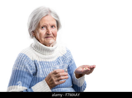 Elderly woman taking her medication over white Stock Photo