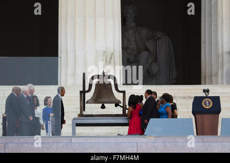 US President Barack Obama, former president Jimmy Carter and Bill Clinton watch as members of the late Dr. Martin Luther King, Jr.'s family ring a bell during the Let Freedom Ring Commemoration and Call to Action to commemorate the 50th anniversary of the Stock Photo