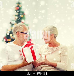 happy senior couple with gift box at home Stock Photo