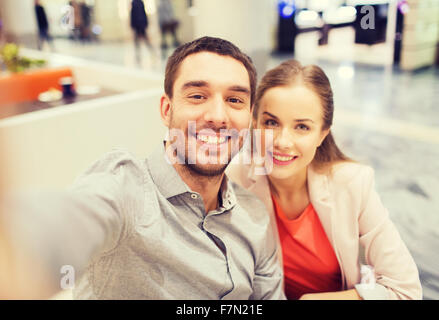 happy couple taking selfie in mall or office Stock Photo