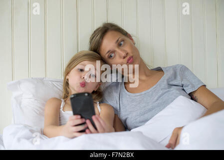 Mother and daughter posing for selfie Stock Photo