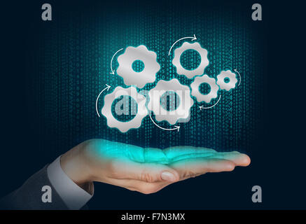 Gears mechanism floats on the human hand Stock Photo