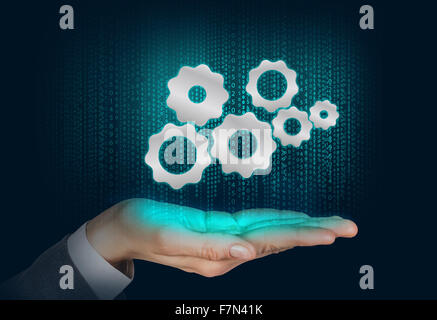 Gears mechanism floats on the human hand Stock Photo