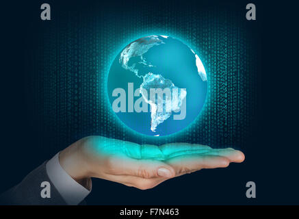 Earth floats on the human hand Stock Photo