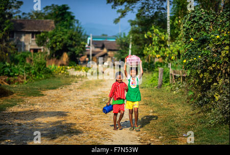 Two nepalese children walking in their village Stock Photo