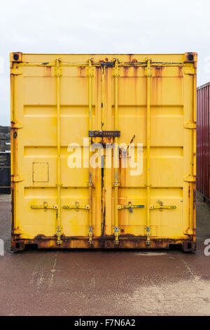 Yellow colored shipping container close up Stock Photo - Alamy