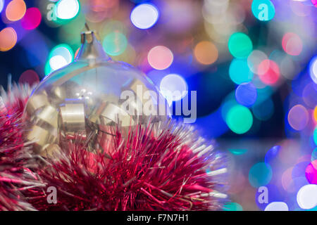 Christmas New Year's toys on a blurred background of Christmas trees and garlands. Stock Photo
