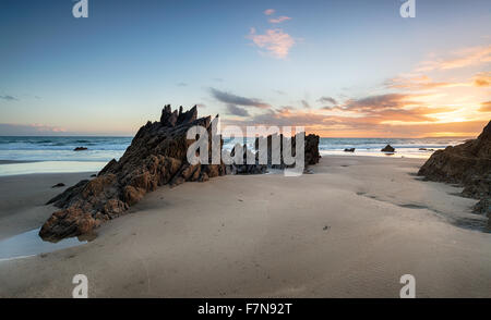 Sunset over rocks at Freathy beach on Whitsand Bay in Cornwall Stock Photo