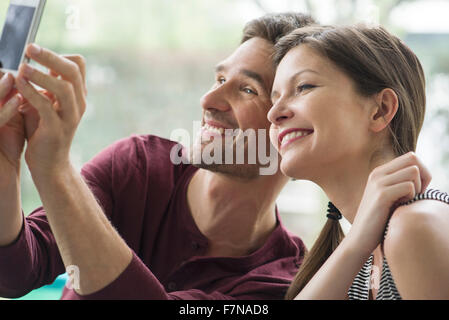 Couple posing for a selfie with a smartphone Stock Photo