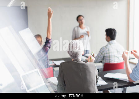 Teacher and students in adult education classroom Stock Photo