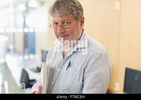 Portrait confident businessman with notebook Stock Photo