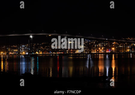 tromsoe city island at night with the bridge connecting the island to the mainland with colorful reflection on sea surface Stock Photo