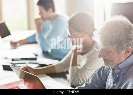 Students studying in adult education classroom Stock Photo