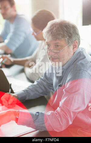 Businessman taking notes in meeting Stock Photo