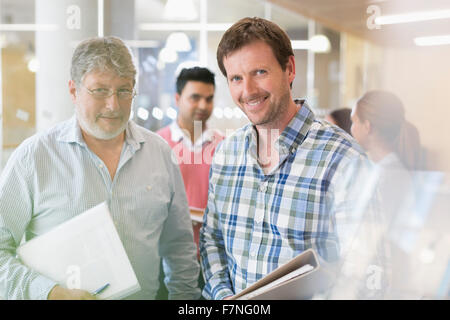 Portrait confident businessmen with notebooks Stock Photo