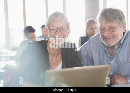 Portrait confident senior woman at laptop in adult education classroom Stock Photo