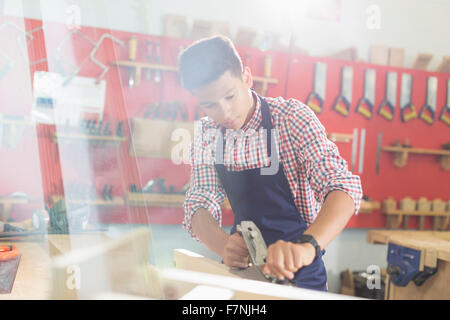 Focused carpenter working in workshop Stock Photo