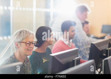 Senior woman at computer in adult education classroom Stock Photo