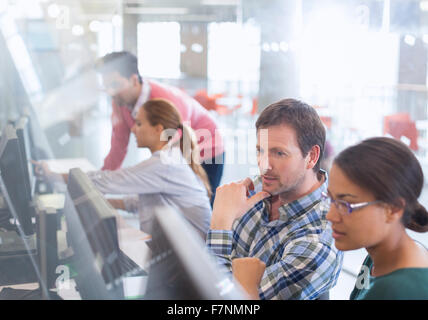 Students at computers in adult education classroom Stock Photo