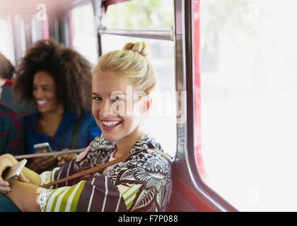 Portrait smiling blonde woman riding bus Stock Photo