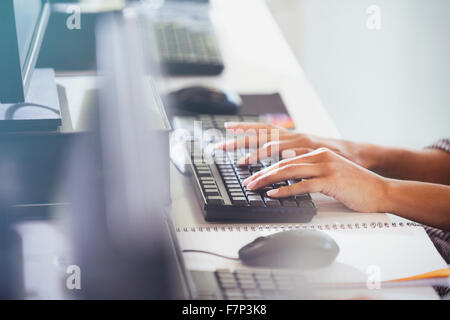 Student typing on computer keyboard in adult education classroom Stock Photo