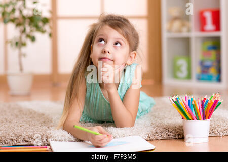 dreamy kid girl drawing with color pencils Stock Photo
