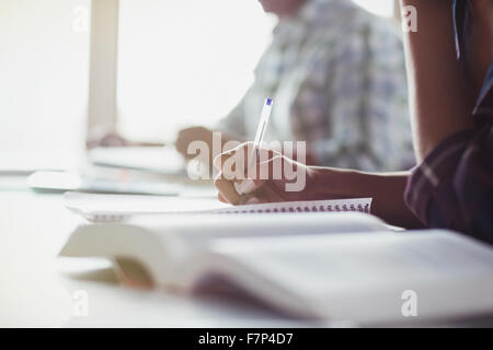 Students taking notes in adult education classroom Stock Photo