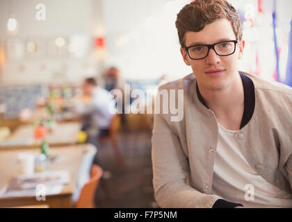 Portrait confident man with eyeglasses in cafe Stock Photo