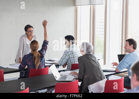 Teacher and students in adult education classroom Stock Photo