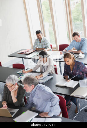 Students studying in adult education classroom Stock Photo