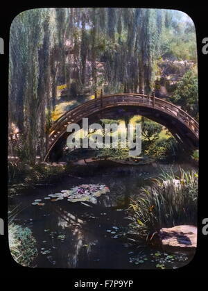 Glass lantern slide, (Hand coloured) of the Drum bridge in the Japanese garden at Henry Edwards Huntington House, San Marino, California. Photographed in 1923 by Frances Benjamin Johnston (1864-1952). Stock Photo