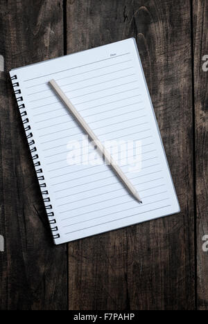 blank notebook and pen  on wooden table, from above Stock Photo