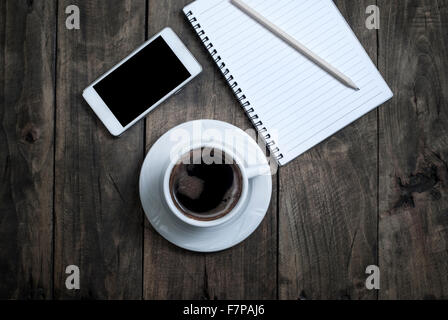 Black  blank screen on the phone and cup of coffee on wooden background Stock Photo