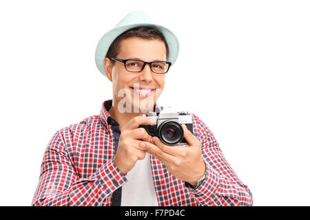 Studio shot of a male photographer holding a camera and posing isolated on white background Stock Photo
