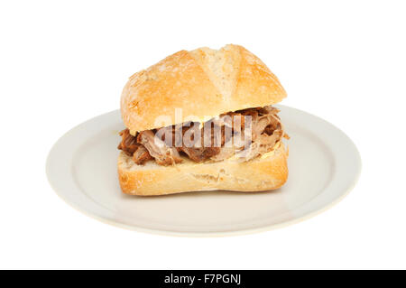 Pulled pork in a sourdough bread roll on a plate isolated against white Stock Photo