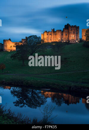 A floodlit Alnwick Castle, home to the Duke and Duchess of Northumberland Stock Photo