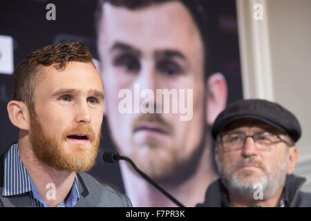 Hamburg, Germany. 02nd Dec, 2015. Irish boxer Dennis Hogan (L) and his coach Steven Deller during a press conference in Hamburg, Germany, 02 December 2015. Germany's Jack Culcay is due to face Ireland's Dennis Hogan in a WBA world super Welterweight bout on 05 December 2015. Photo: CHRISTIAN CHARISIUS/dpa/Alamy Live News Stock Photo